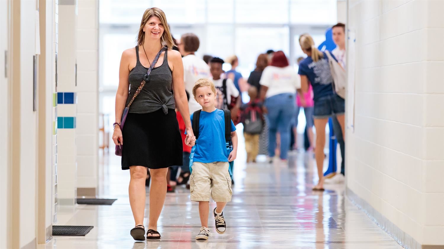A prospective WCPSS parent is walking with her son during a school visit. A prospective WCPSS parent is walking with her son during a school visit.